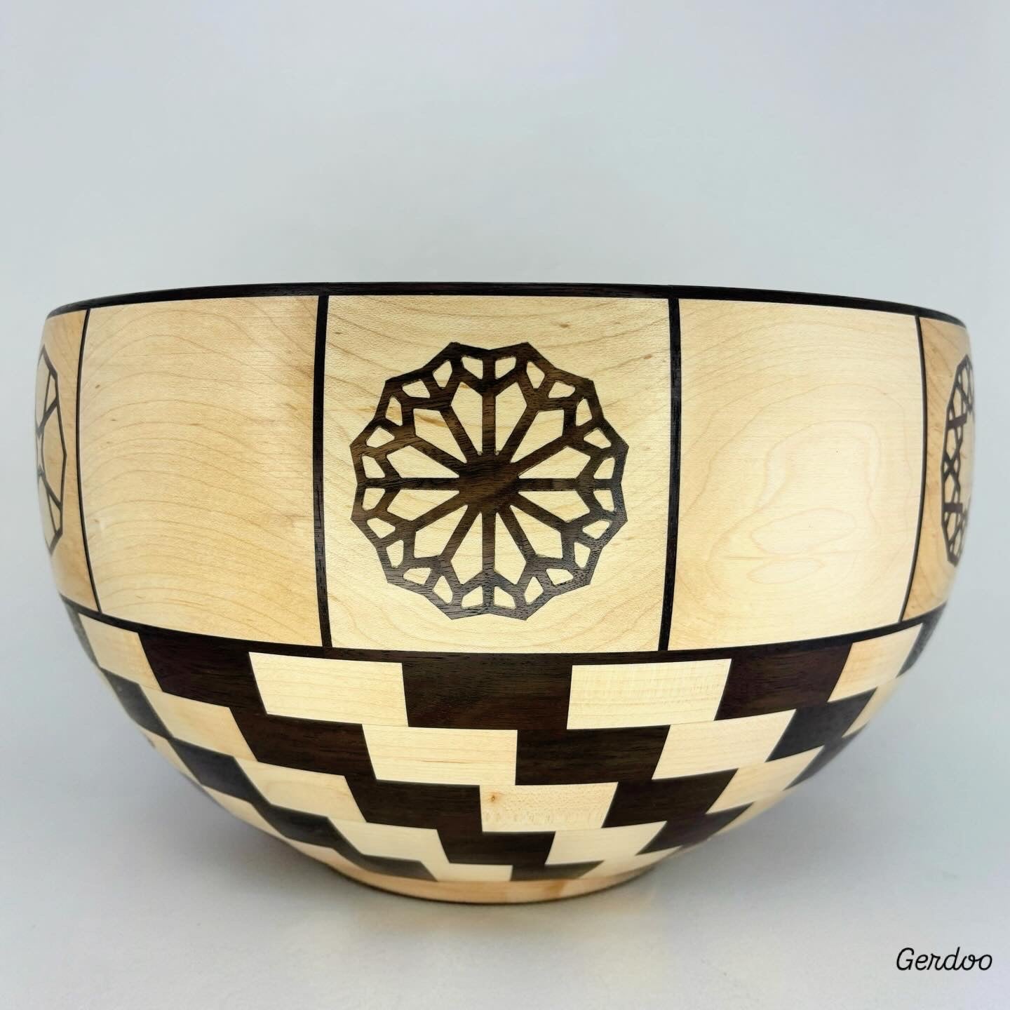 Wooden bowl with geometric patterns on a light gray background